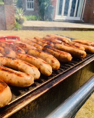 Sausages being cooked on our BBQ
